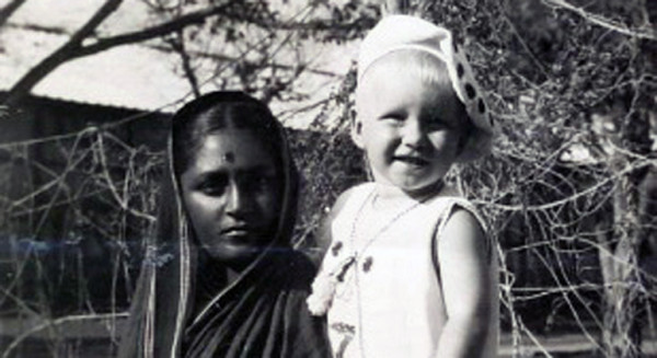A Polish child in the arms of an Indian woman. 