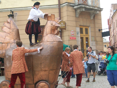 The Jarmark festival spokesman and his assistants make their way through old town, calling visitors to different events of the day.