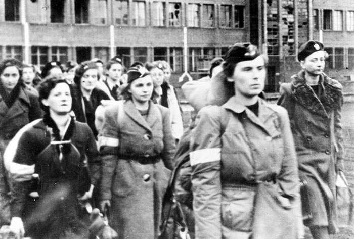 Polish POWs wear their red-and-white Uprising armbands in Oberlangen; 1944.