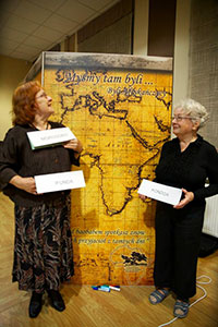 Two friends stand in front of a map of Africa, on which attendees wrote their names where their settlements were located; the title reads "We were there..."