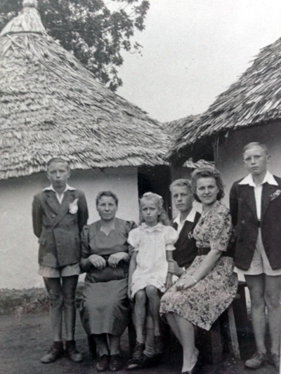 The Mikut family in front of the two huts they shared in the Polish orphanage in Tanzania; c. 1946. 
